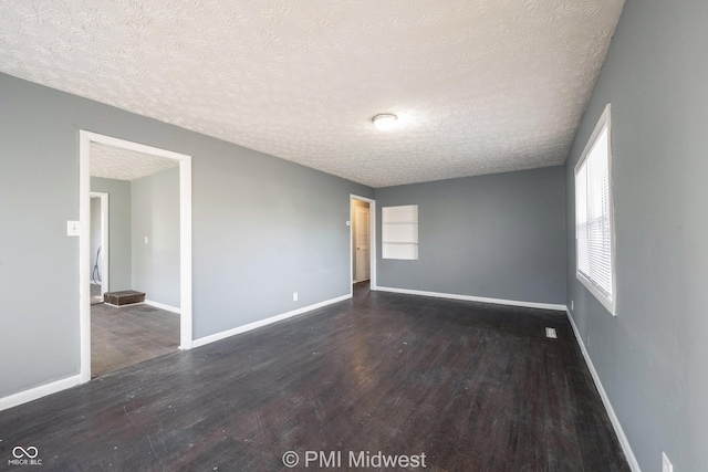 5737 E 22nd St, Indianapolis, IN 46218 - spare room featuring a textured ceiling and wood finished floors