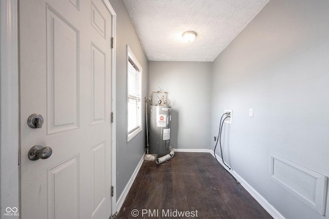 5737 E 22nd St, Indianapolis, IN 46218 - laundry area featuring water heater, dark wood finished floors, a textured ceiling, and washer hookup