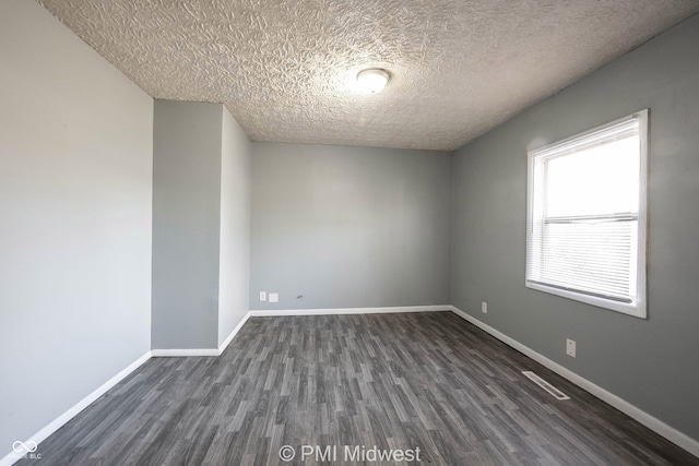 5737 E 22nd St, Indianapolis, IN 46218 - spare room with dark wood-style flooring and a textured ceiling