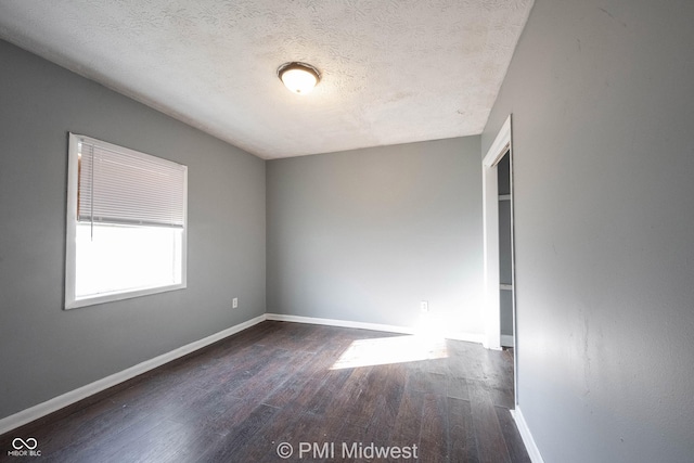 5737 E 22nd St, Indianapolis, IN 46218 - spare room with wood finished floors and a textured ceiling
