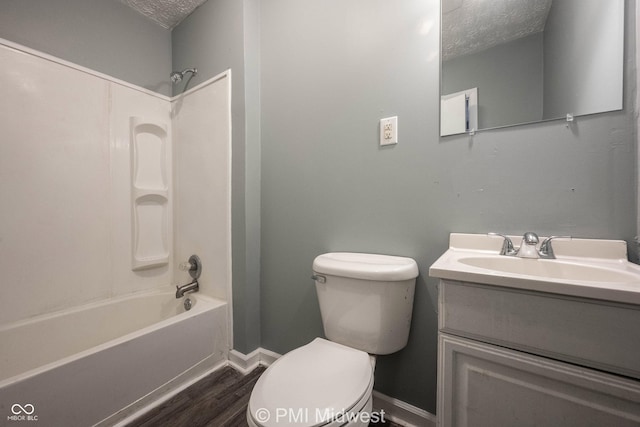 5737 E 22nd St, Indianapolis, IN 46218 - bathroom featuring a textured ceiling, wood finished floors, vanity, and tub / shower combination