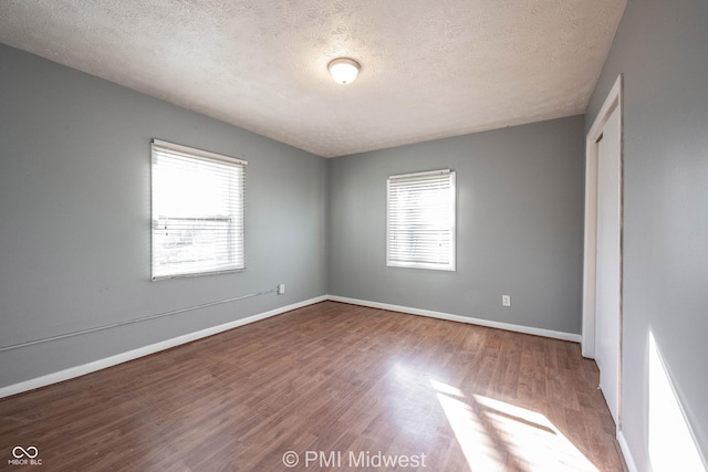 5737 E 22nd St, Indianapolis, IN 46218 - unfurnished room with wood finished floors and a textured ceiling