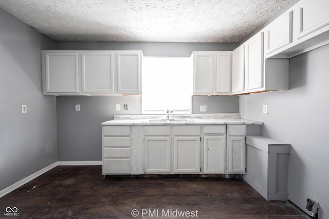 5737 E 22nd St, Indianapolis, IN 46218 - kitchen featuring dark wood-type flooring, white cabinets, and a textured ceiling