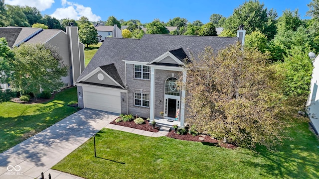 441 Viburnum Run, Westfield, IN 46074 - greek revival inspired property with concrete driveway, a chimney, a garage, a front lawn, and brick siding