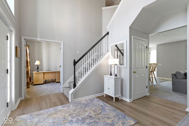 441 Viburnum Run, Westfield, IN 46074 - entrance foyer featuring wood finished floors, stairs, and a towering ceiling