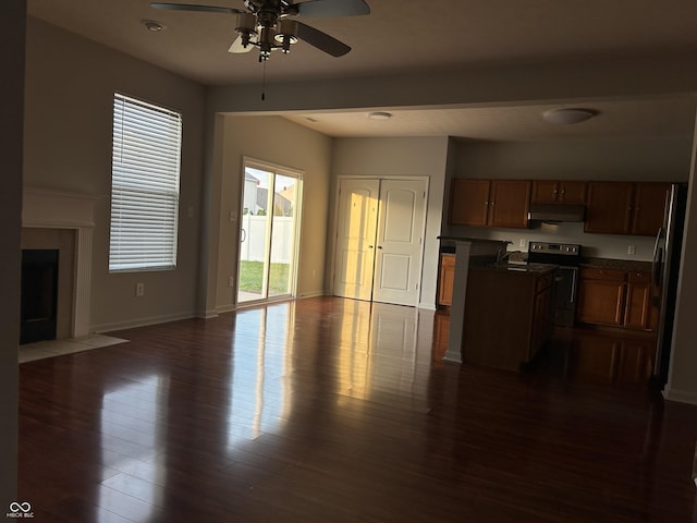 7854 Newhall Way, Indianapolis, IN 46239 - kitchen with under cabinet range hood, dark countertops, stainless steel appliances, ceiling fan, and open floor plan