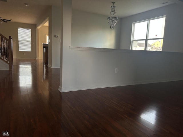 7854 Newhall Way, Indianapolis, IN 46239 - spare room with stairway, dark wood-style floors, and a chandelier