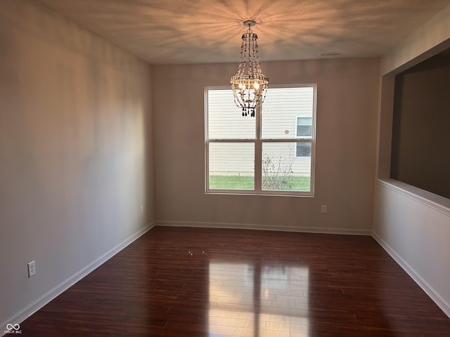 7854 Newhall Way, Indianapolis, IN 46239 - unfurnished room with a chandelier and dark wood-style floors