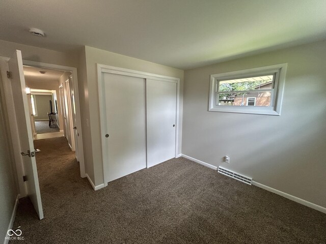 2692 Meadowlark Ln, Columbus, IN 47201 - unfurnished bedroom featuring dark colored carpet and a closet