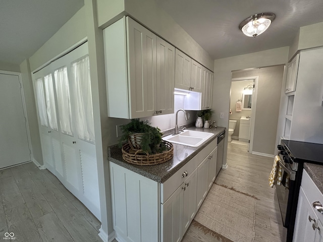 2692 Meadowlark Ln, Columbus, IN 47201 - kitchen featuring appliances with stainless steel finishes, light wood-style floors, and white cabinets