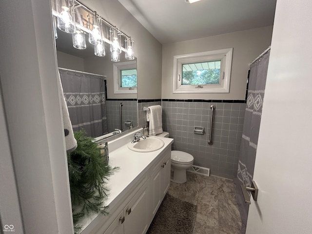 2692 Meadowlark Ln, Columbus, IN 47201 - bathroom featuring vanity, a wainscoted wall, and tile walls