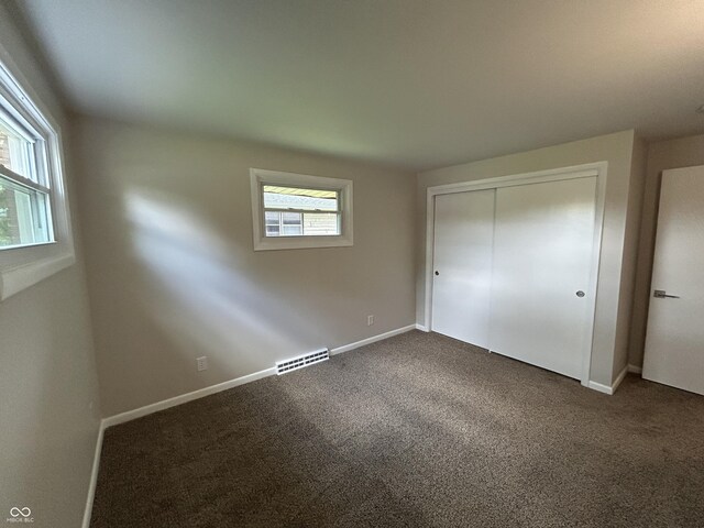 2692 Meadowlark Ln, Columbus, IN 47201 - unfurnished bedroom with dark colored carpet and a closet