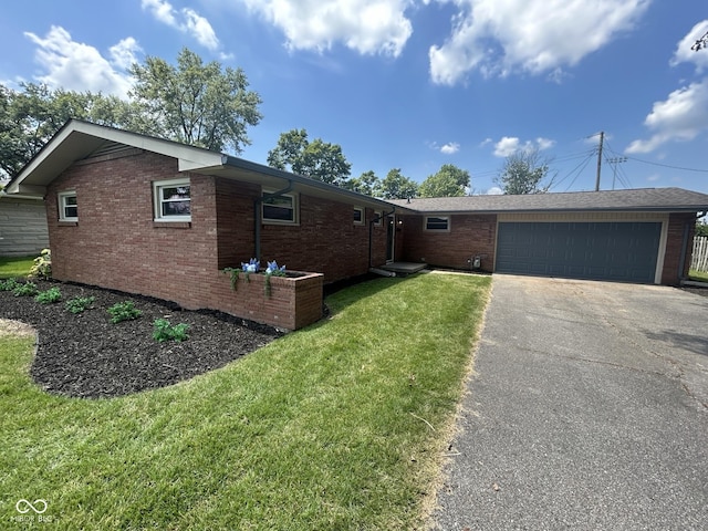 2692 Meadowlark Ln, Columbus, IN 47201 - single story home featuring brick siding, driveway, a front yard, and a garage