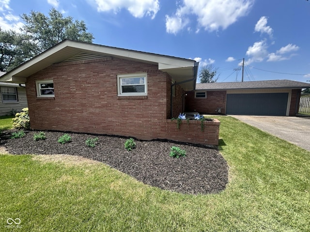 2692 Meadowlark Ln, Columbus, IN 47201 - view of home's exterior featuring concrete driveway, a yard, brick siding, and a garage