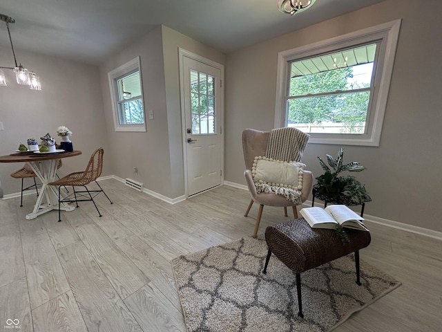 2692 Meadowlark Ln, Columbus, IN 47201 - sitting room with light wood finished floors and a chandelier