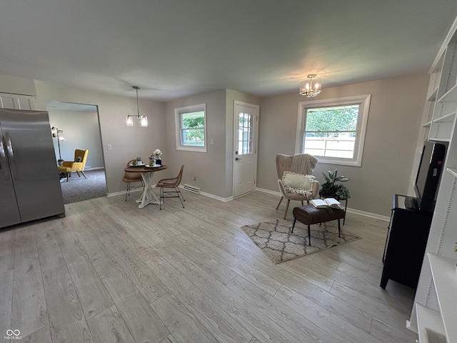 2692 Meadowlark Ln, Columbus, IN 47201 - living room featuring a chandelier, plenty of natural light, and light wood-style floors
