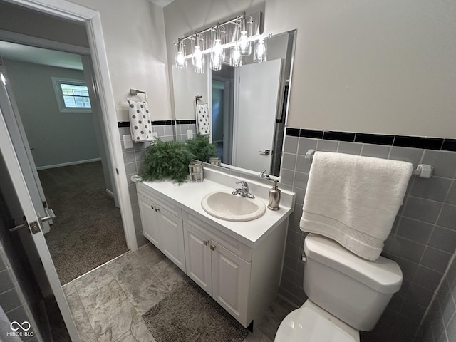 2692 Meadowlark Ln, Columbus, IN 47201 - bathroom with tile walls, vanity, and wainscoting