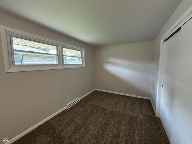 2692 Meadowlark Ln, Columbus, IN 47201 - spare room with dark colored carpet and baseboards
