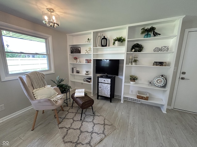 2692 Meadowlark Ln, Columbus, IN 47201 - living area featuring light wood-style flooring and a chandelier