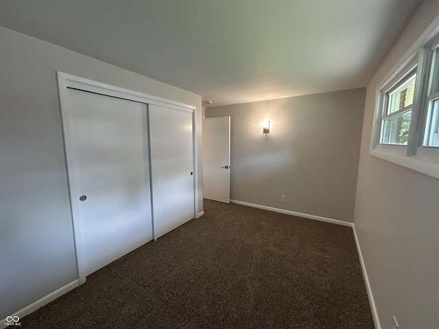 2692 Meadowlark Ln, Columbus, IN 47201 - unfurnished bedroom featuring dark carpet and a closet