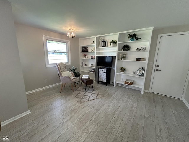 2692 Meadowlark Ln, Columbus, IN 47201 - sitting room with light wood-style flooring and a chandelier