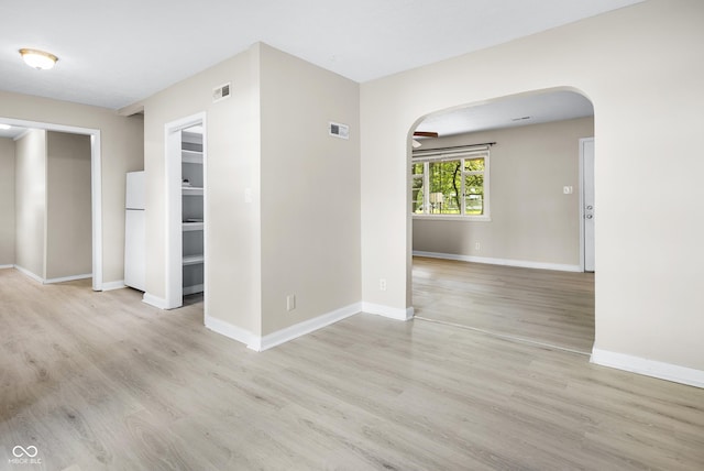 3945 N Ridgeview Dr, Indianapolis, IN 46226 - empty room featuring arched walkways and light wood-style floors