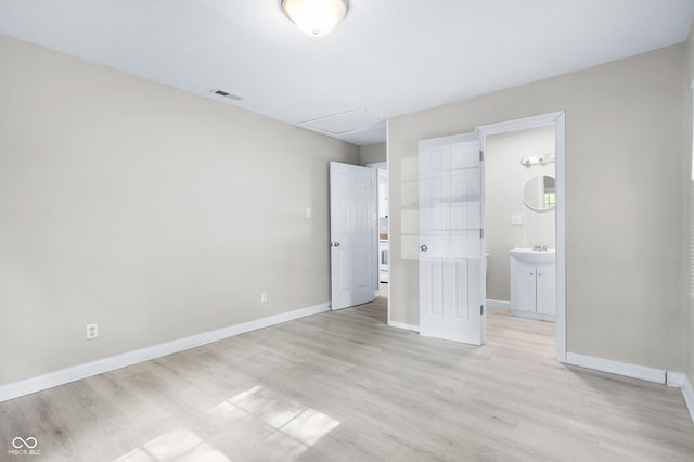 3945 N Ridgeview Dr, Indianapolis, IN 46226 - unfurnished bedroom featuring light wood-type flooring, connected bathroom, and attic access