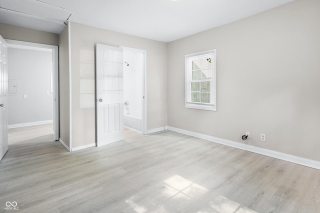 3945 N Ridgeview Dr, Indianapolis, IN 46226 - unfurnished bedroom featuring light wood-style flooring and connected bathroom