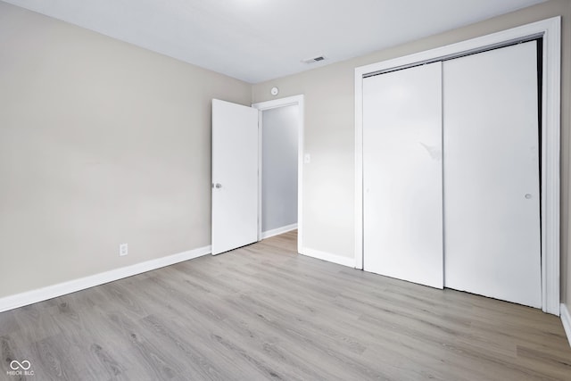 3945 N Ridgeview Dr, Indianapolis, IN 46226 - unfurnished bedroom with wood finished floors and a closet
