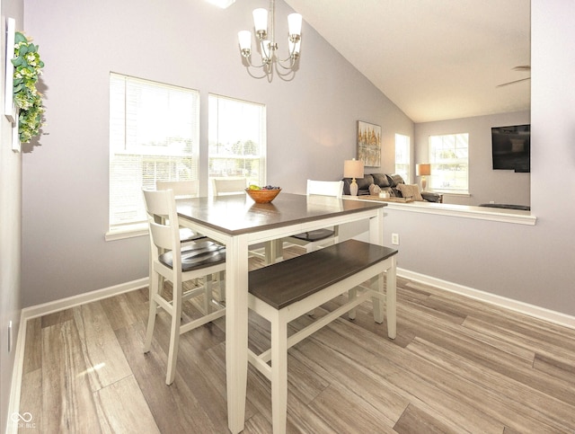 17019 Flinchum Way E, Noblesville, IN 46062 - dining room with light wood-style flooring, a chandelier, and vaulted ceiling