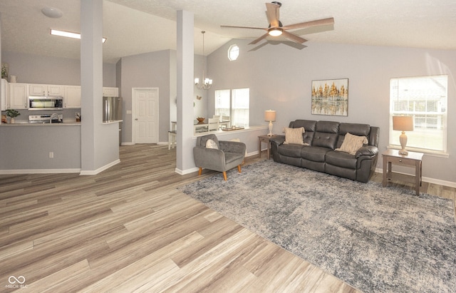 17019 Flinchum Way E, Noblesville, IN 46062 - living area with a chandelier, ceiling fan, light wood-style flooring, and high vaulted ceiling