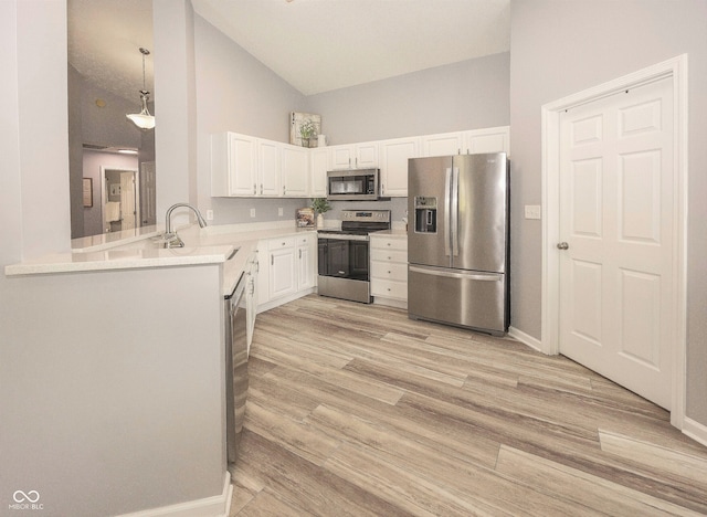 17019 Flinchum Way E, Noblesville, IN 46062 - kitchen with stainless steel appliances, white cabinetry, light countertops, light wood-type flooring, and high vaulted ceiling