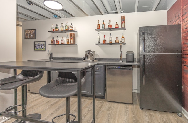 17019 Flinchum Way E, Noblesville, IN 46062 - indoor wet bar with freestanding refrigerator, light wood-style flooring, and stainless steel dishwasher