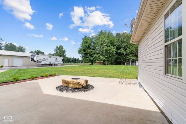 606 S Grange Hall Rd, Hanover, IN 47243 - view of patio featuring an outdoor fire pit and a garage