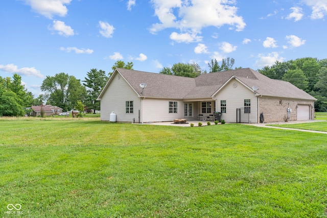 606 S Grange Hall Rd, Hanover, IN 47243 - rear view of house featuring a lawn, a patio, an attached garage, and a shingled roof