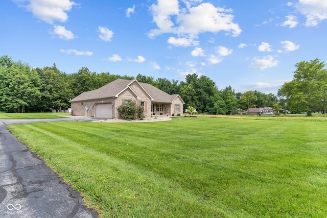 606 S Grange Hall Rd, Hanover, IN 47243 - view of side of property featuring a garage, driveway, a lawn, and brick siding