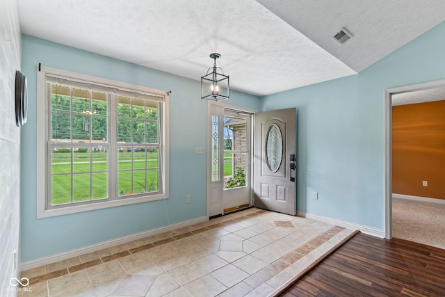 606 S Grange Hall Rd, Hanover, IN 47243 - foyer with a textured ceiling and a chandelier