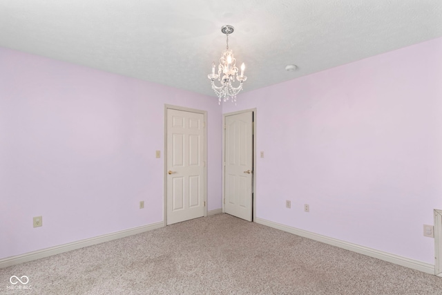 606 S Grange Hall Rd, Hanover, IN 47243 - empty room with light colored carpet and a chandelier