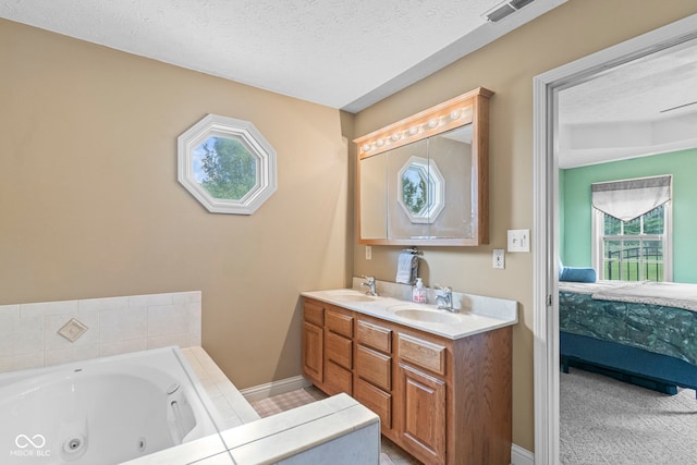 606 S Grange Hall Rd, Hanover, IN 47243 - bathroom with healthy amount of natural light, ensuite bathroom, double vanity, a whirlpool tub, and a textured ceiling