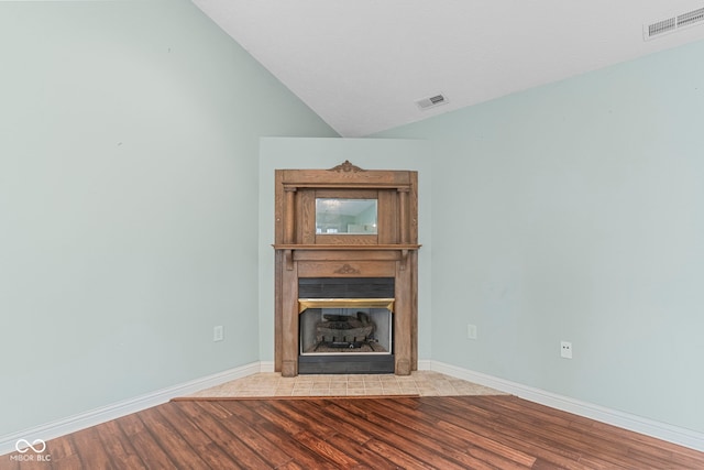 606 S Grange Hall Rd, Hanover, IN 47243 - unfurnished living room with wood finished floors, a fireplace, and lofted ceiling