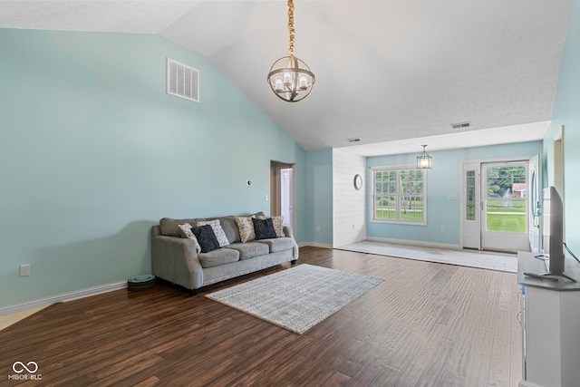 606 S Grange Hall Rd, Hanover, IN 47243 - unfurnished living room featuring a chandelier, wood finished floors, and high vaulted ceiling