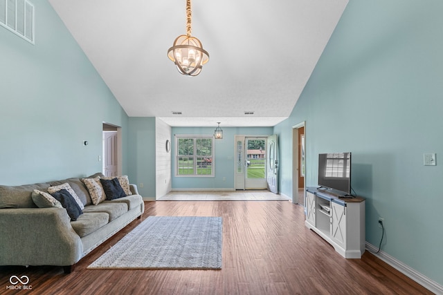 606 S Grange Hall Rd, Hanover, IN 47243 - living room featuring a chandelier, wood finished floors, and high vaulted ceiling