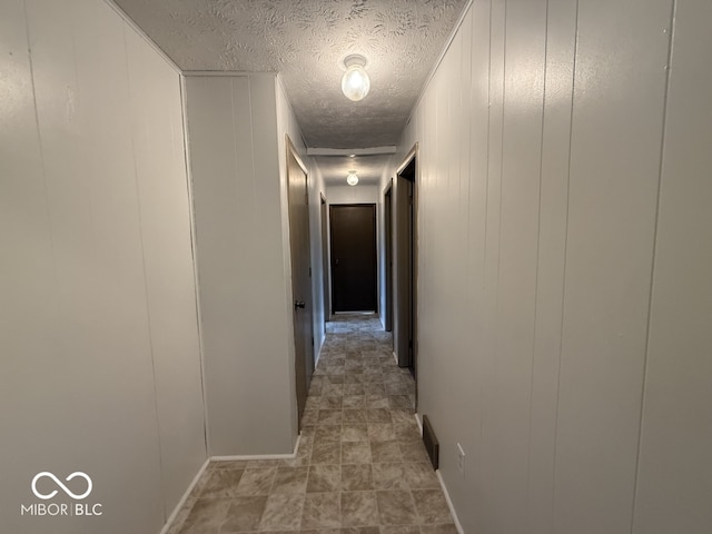 1048 S Burlington Dr, Muncie, IN 47302 - corridor featuring a textured ceiling and a decorative wall