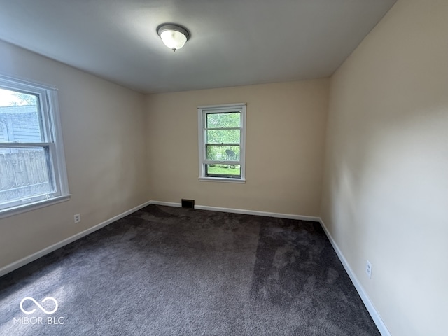 1048 S Burlington Dr, Muncie, IN 47302 - empty room featuring dark carpet and baseboards