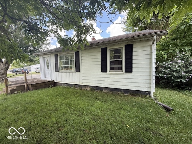 1048 S Burlington Dr, Muncie, IN 47302 - view of front facade featuring a front yard and a chimney