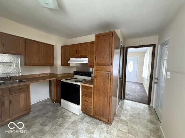 1048 S Burlington Dr, Muncie, IN 47302 - kitchen with white range with electric cooktop, brown cabinetry, under cabinet range hood, and decorative backsplash