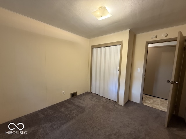 1048 S Burlington Dr, Muncie, IN 47302 - unfurnished bedroom featuring carpet flooring and a closet