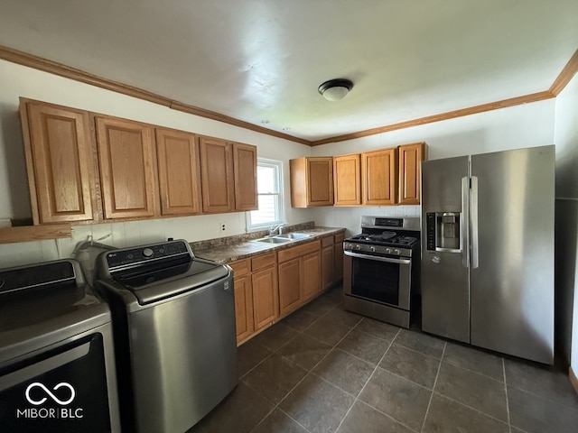 1914 E 23rd St, Muncie, IN 47302 - kitchen with appliances with stainless steel finishes, washer and clothes dryer, dark tile patterned flooring, dark countertops, and ornamental molding