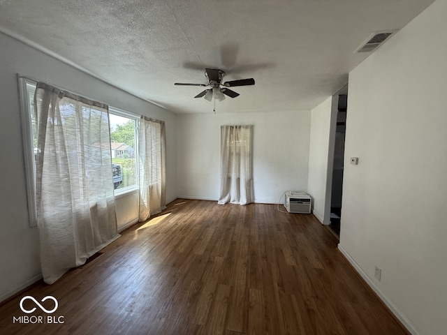 1914 E 23rd St, Muncie, IN 47302 - unfurnished room with wood finished floors, ceiling fan, a textured ceiling, and a wall mounted AC
