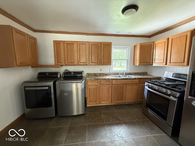 1914 E 23rd St, Muncie, IN 47302 - kitchen featuring separate washer and dryer, stainless steel appliances, crown molding, dark countertops, and dark tile patterned flooring